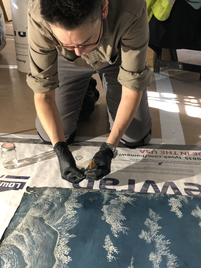 Conservator working on panel
