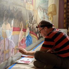 Artist during work on murals