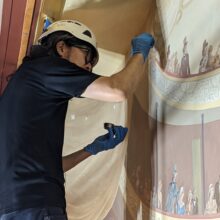 Artist during work on murals