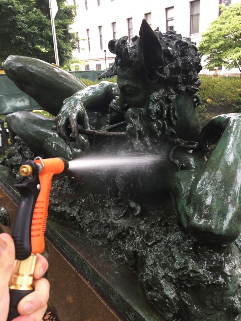 The Great God Pan, Rinsing the statue during cleaning